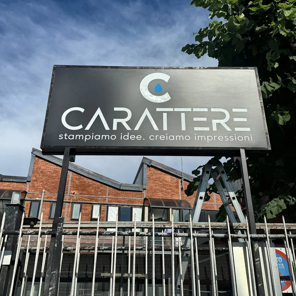 Insegna di Carattere con logo e slogan davanti alla sede